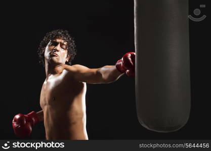 Male boxer hitting heavy bag