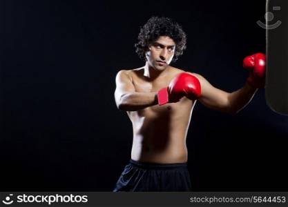 Male boxer punching the bag
