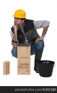 Male bricklayer with confused look on face