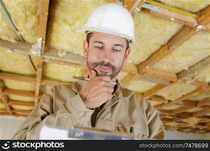 male builder checking his clipboard