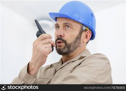 male builder using walkie talkie