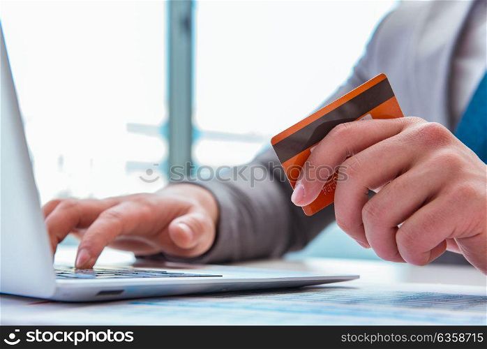 Male businessman doing online shopping with credit card