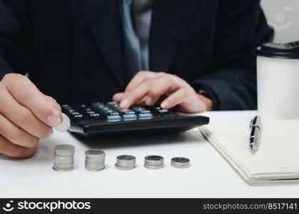 male businessman use calculator money coin financial tax and planning investments marketing economy income and retirement saving.