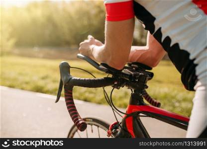 Male bycyclist in sportswear, cycling on bike path. Sportsman rides on bicycle