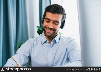 Male call center operator or telesales representative siting at his office desk wearing headset and engaged in conversation with client providing customer service support or making a sale. fervent. Male call center operator or telesales agent working on his desk. fervent