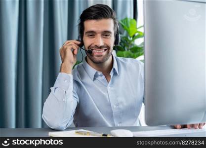 Male call center operator or telesales representative siting at his office desk wearing headset portrait. Customer service agent with smiling to camera on workplace. fervent. Male call center operator or telesales agent portrait. fervent