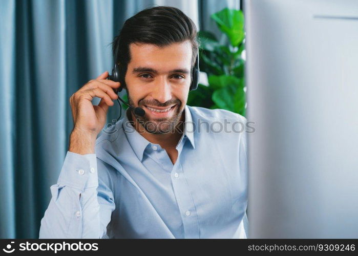 Male call center operator or telesales representative siting at his office desk wearing headset portrait. Customer service agent with smiling to camera on workplace. fervent. Male call center operator or telesales agent portrait. fervent