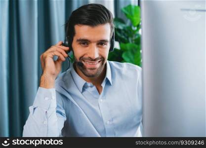 Male call center operator or telesales representative siting at his office desk wearing headset portrait. Customer service agent with smiling to camera on workplace. fervent. Male call center operator or telesales agent portrait. fervent