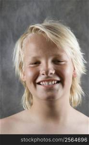Male Caucasian adolescent portrait smiling.