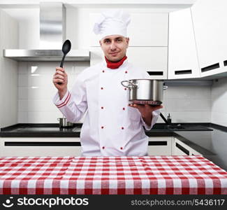 Male chef at kitchen getting ready to cook