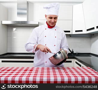 Male chef at kitchen getting ready to cook