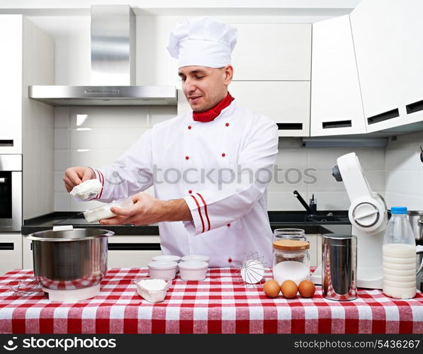 Male chef at kitchen getting ready to cook