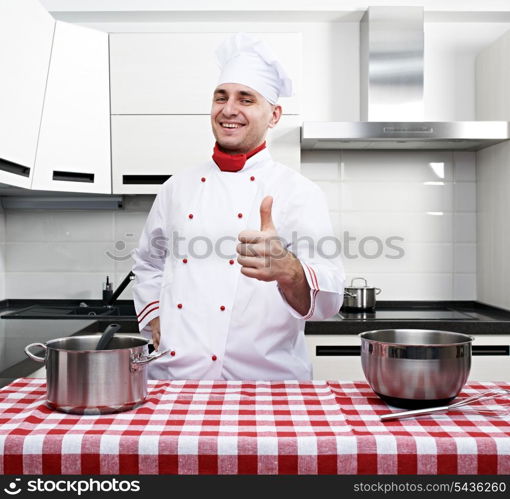 Male chef at kitchen with thumb up