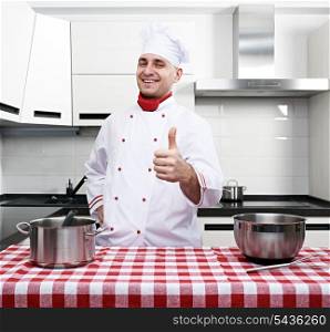 Male chef at kitchen with thumb up