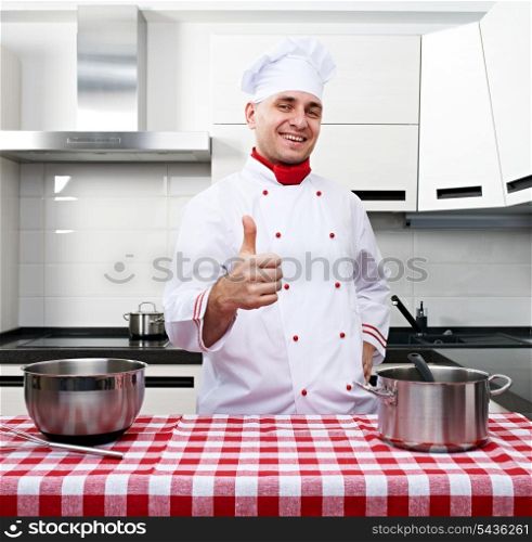 Male chef at kitchen with thumb up