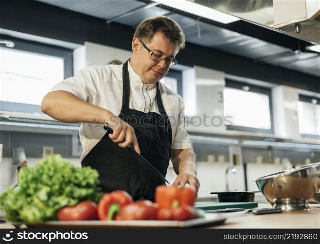 male chef chopping tomatoes kitchen