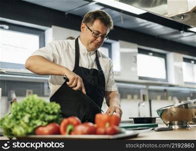male chef chopping tomatoes kitchen