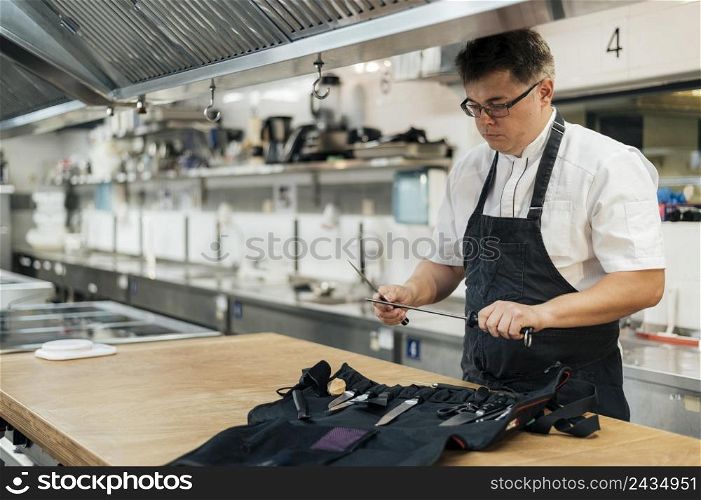 male chef kitchen preparing his tools