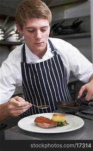 Male Chef Preparing Meal In Restaurant Kitchen