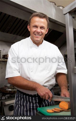 Male Chef Preparing Vegetables In Restaurant Kitchen