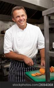 Male Chef Preparing Vegetables In Restaurant Kitchen