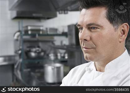 Male chef smiling in kitchen