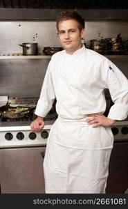 Male Chef Standing Next To Cooker In Restaurant Kitchen