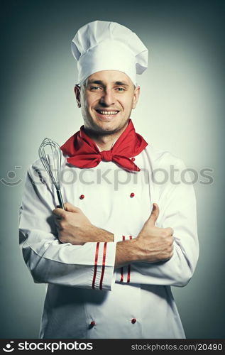 Male chef with thumb up portrait against grey background