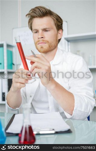 male chemist analyzes blood in a lab