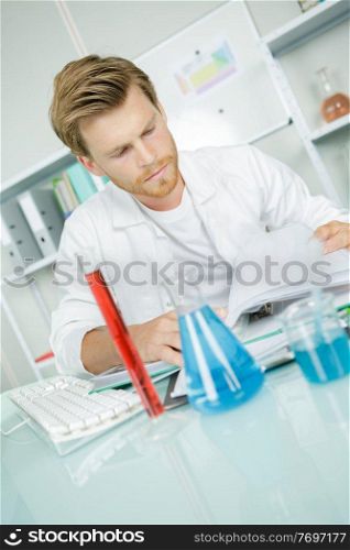 male chemist with chemical liquid shot indoor