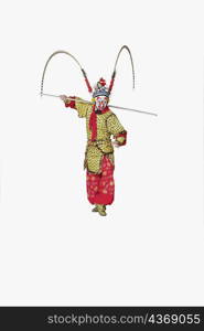 Male Chinese opera performer gesturing with a weapon