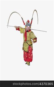 Male Chinese opera performer gesturing with a weapon