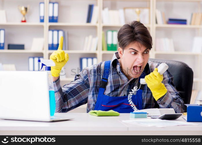 Male cleaner working in the office