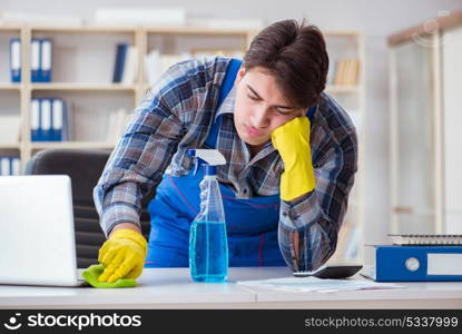 Male cleaner working in the office