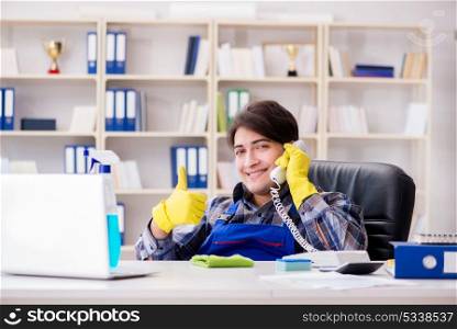 Male cleaner working in the office