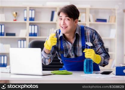 Male cleaner working in the office. The male cleaner working in the office