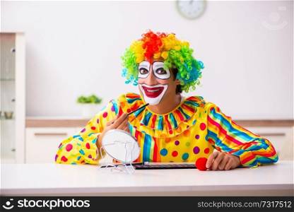 Male clown preparing for perfomance at home 