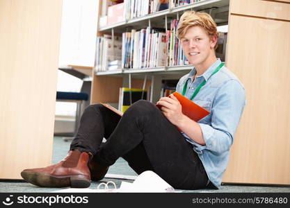 Male College Student Studying In Library