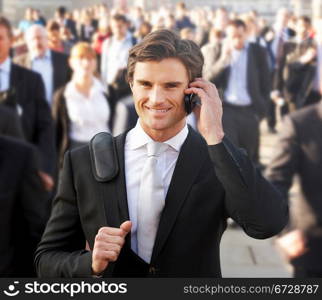 Male commuter in crowd using phone