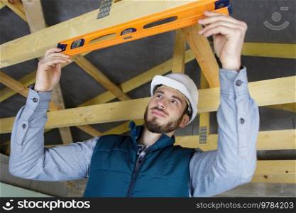male construction worker adjusting ceiling part