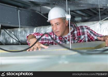 male construction worker in the ceiling