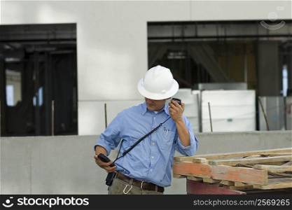 Male construction worker talking on a CB radio