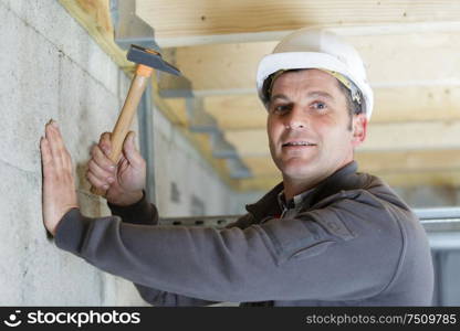 male construction worker using a hammer