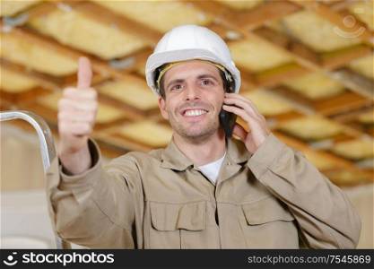 male constructor on the phone