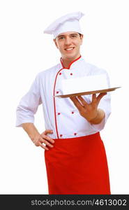 Male cook in uniform holding an empty tray