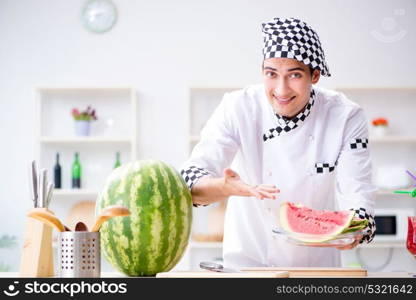 Male cook with watermelon in kitchen