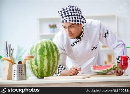 Male cook with watermelon in kitchen