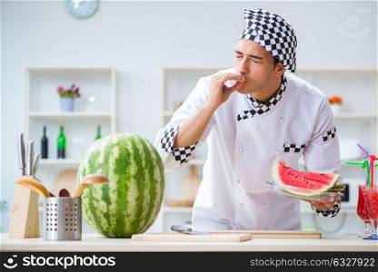 Male cook with watermelon in kitchen. The male cook with watermelon in kitchen