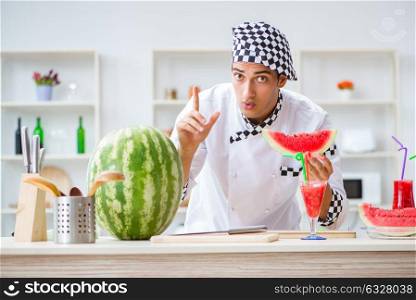 Male cook with watermelon in kitchen. The male cook with watermelon in kitchen