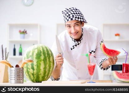 Male cook with watermelon in kitchen. The male cook with watermelon in kitchen